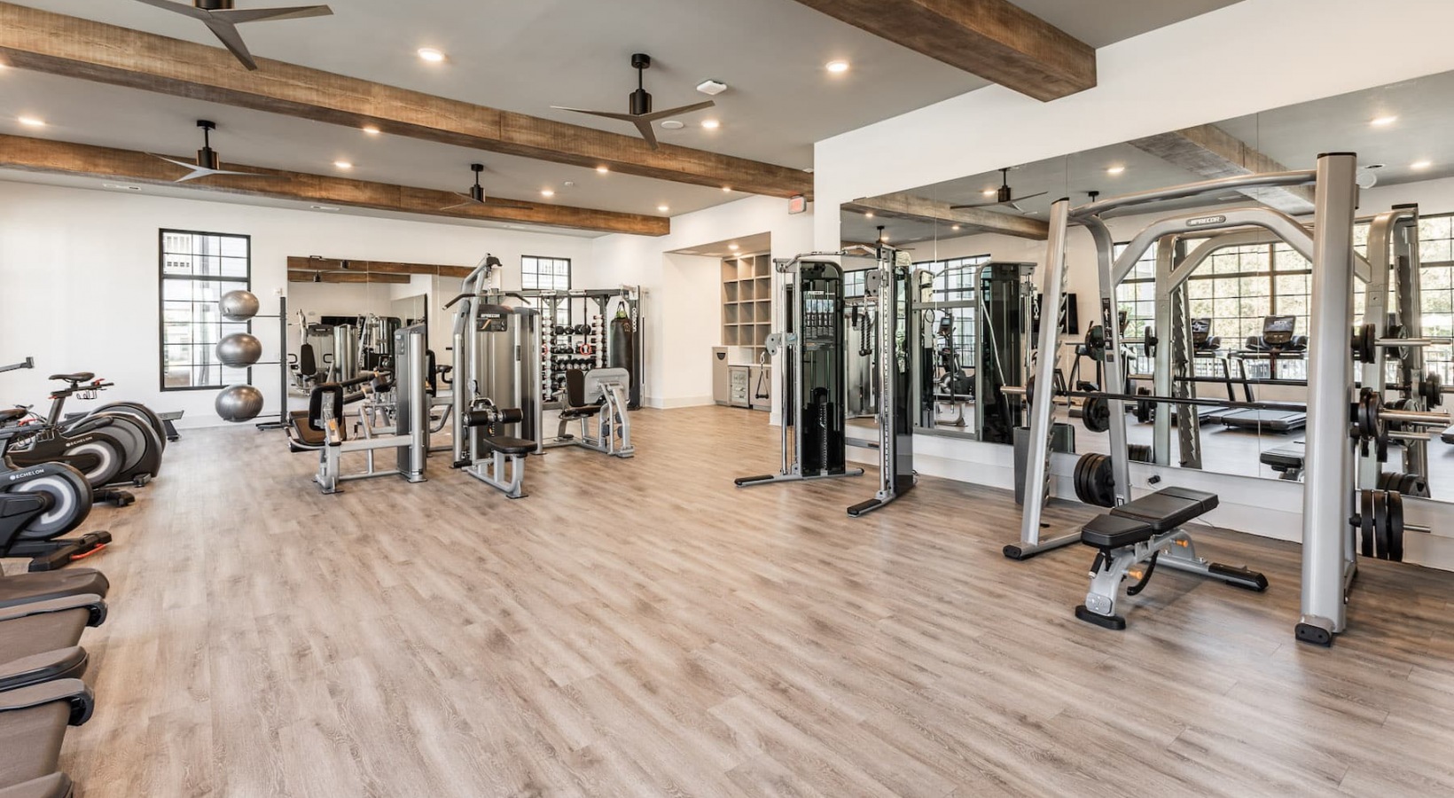 fitness center rendering showing plenty of equipment and modern decor in a large, spacious room