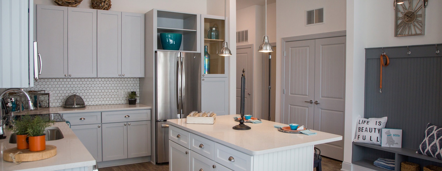 Large kitchen island in kitchen with white cabinetry