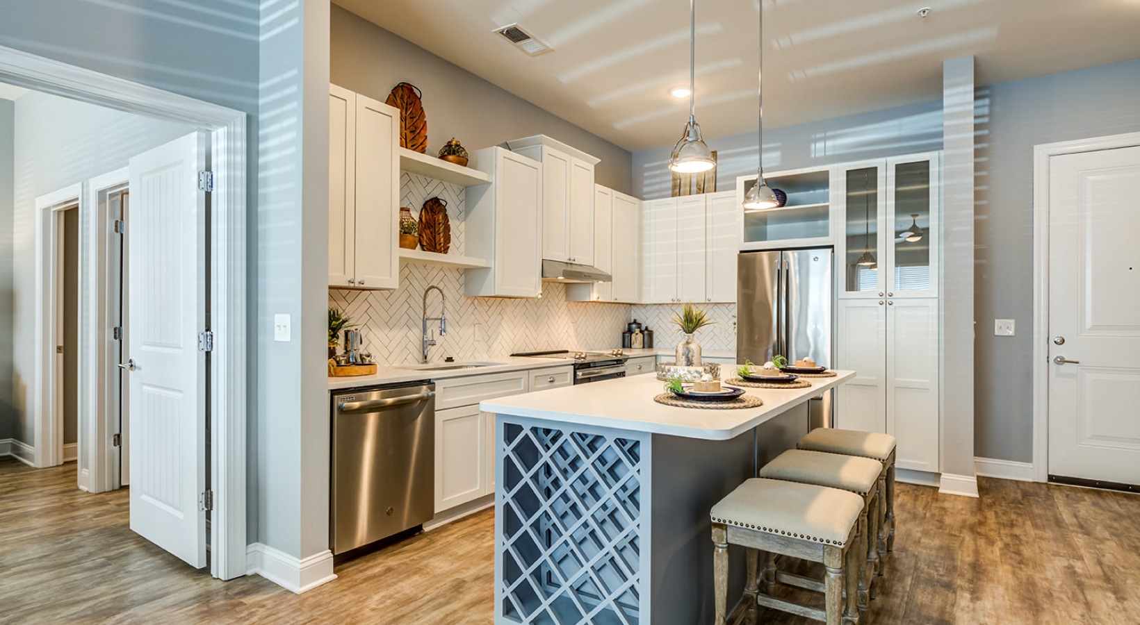 Large, modern-styled kitchen space and large island with wine rack