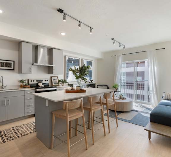 a kitchen and living room with a table and chairs at Paperbox Lofts, Salt Lake City, UT, 84101