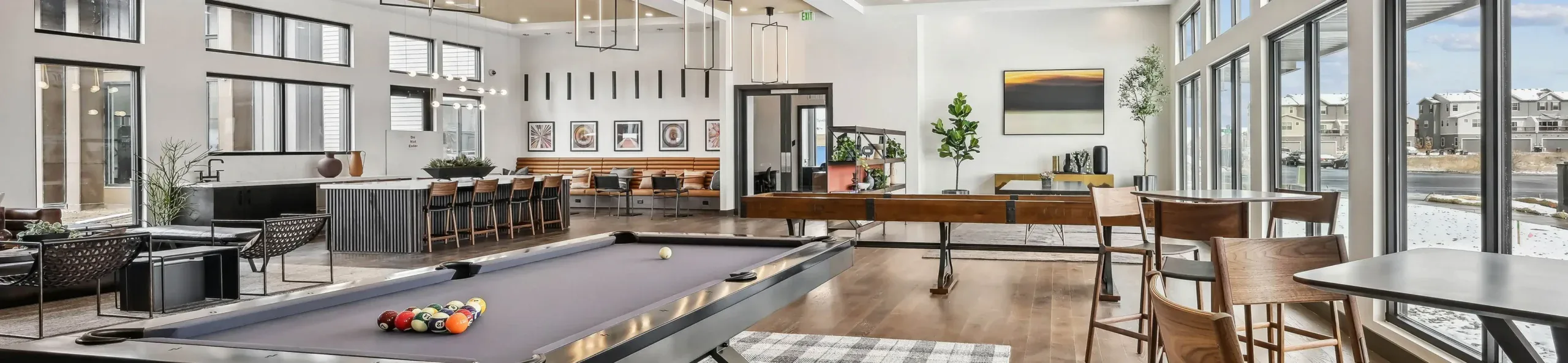 A modern home featuring a sleek pool table and a stylish bar area, showcasing contemporary design elements.