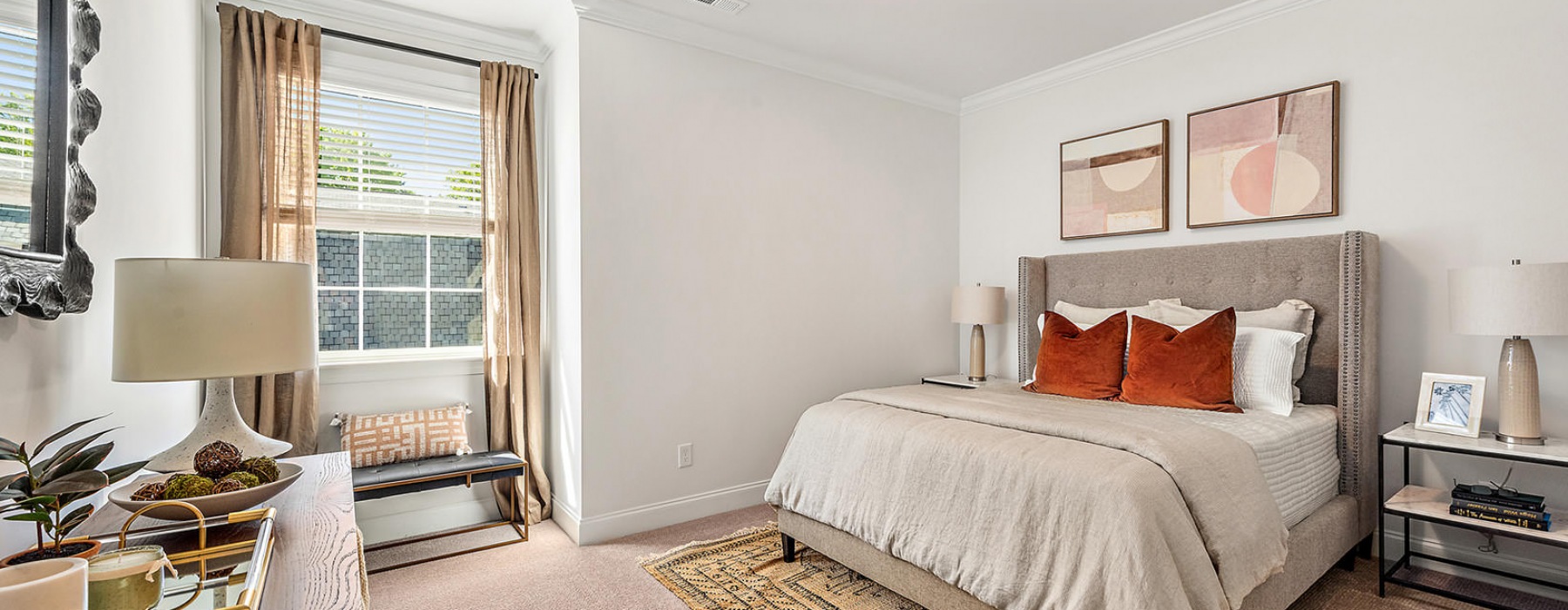 spacious bedroom with light fixture and large window