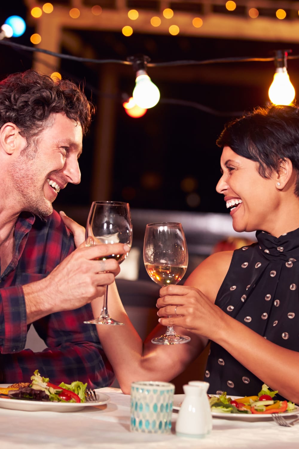 Residents clinking glasses at a restaurant near Sofi Gaslight Commons in South Orange, New Jersey