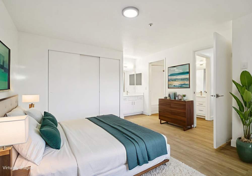 Model bedroom with wood-style flooring at Foundry on Fifth in Renton, Washington
