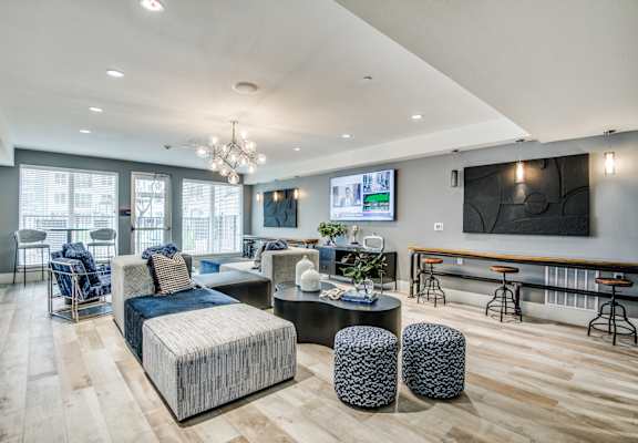 A modern living room with a large couch and a television.
