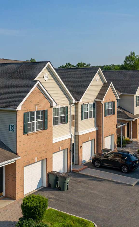 a row of houses with a car parked in a parking lot