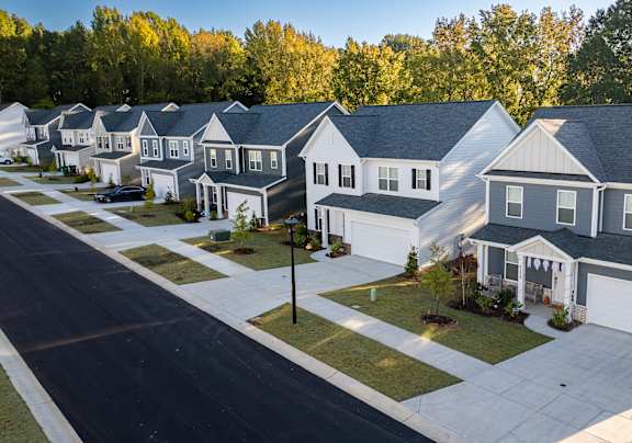 A row of houses with a street in front.