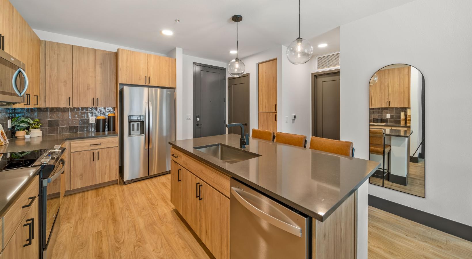 a kitchen with wooden cabinets and an island