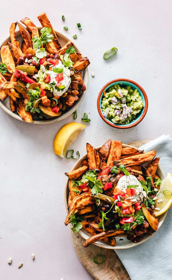 a white table topped with bowls of different types of food