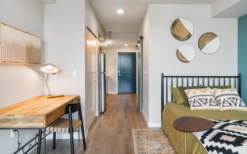 a bedroom with a bed and a desk