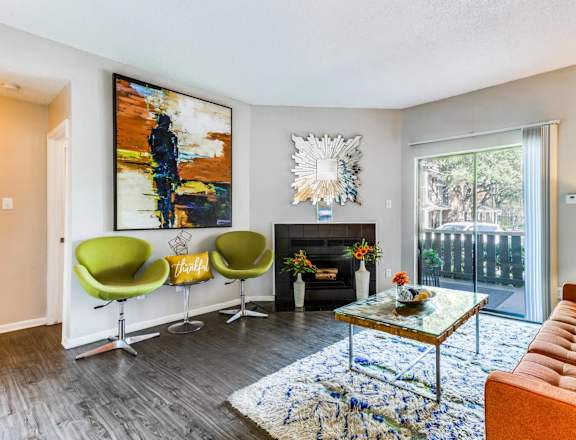 A living room with a fireplace and a painting on the wall.