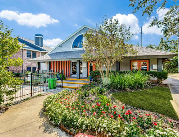 A house with a front yard and a fence.