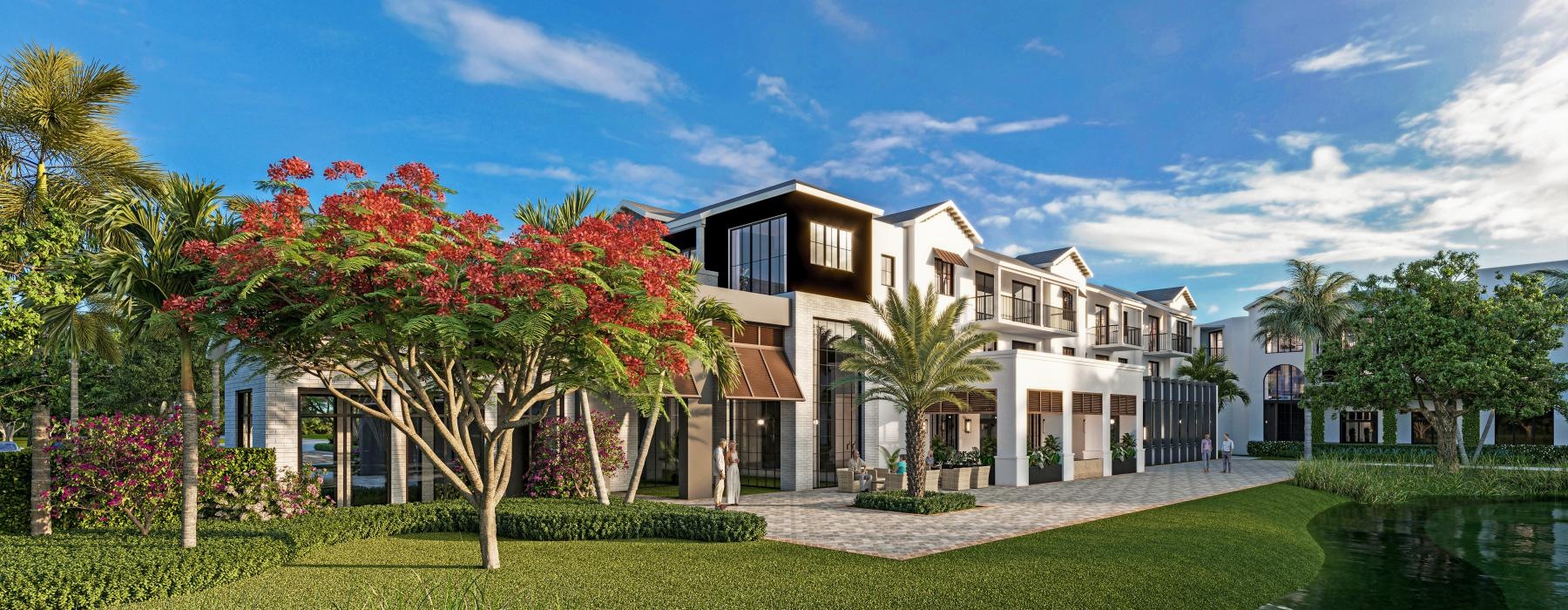 a building with palm trees and a pond in front of it