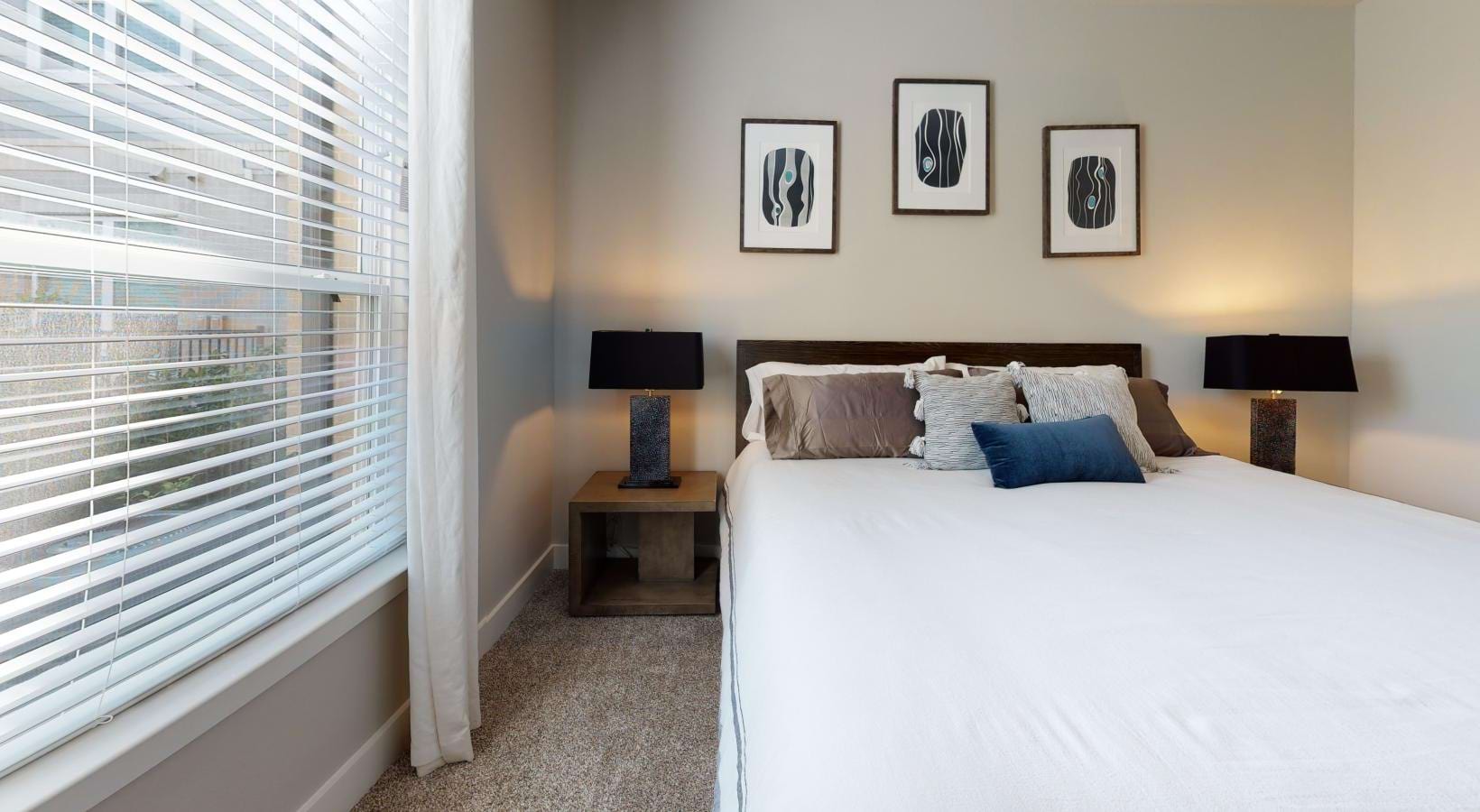a bedroom with a bed with a lamp on the side