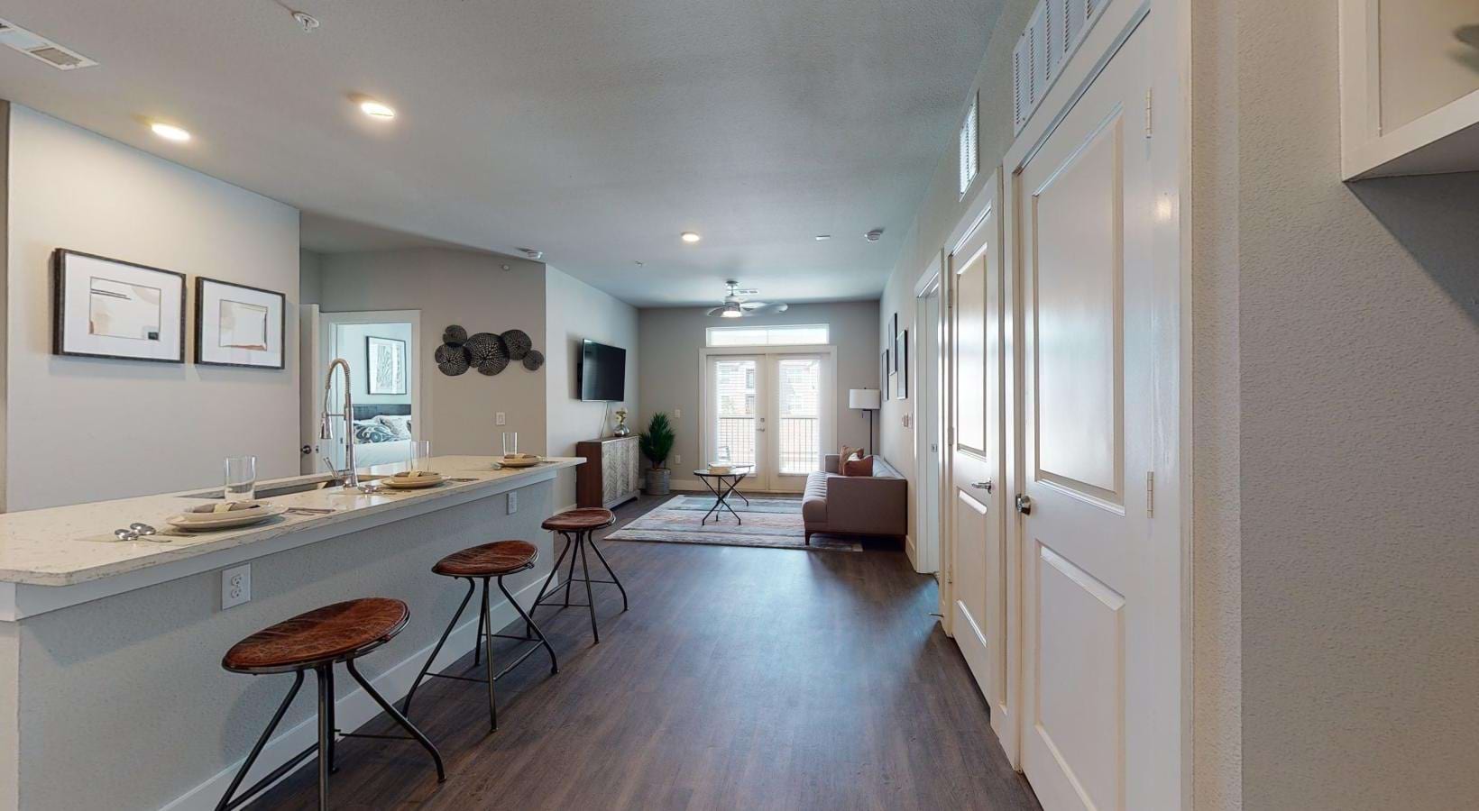a kitchen with a kitchen island bar and stools
