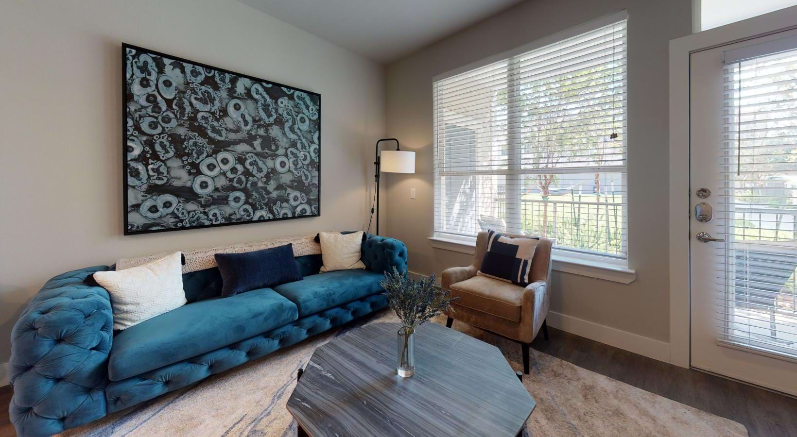 a living room with a blue couch and windows