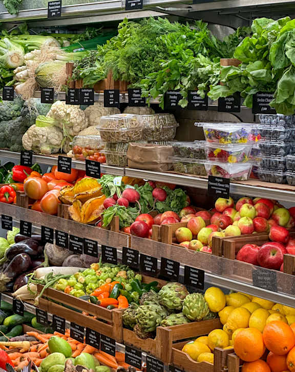 A fruit and vegetable stand with a variety of produce.