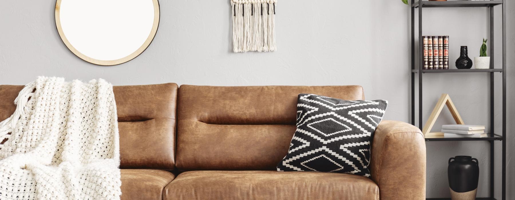 a couch with a mirror above it