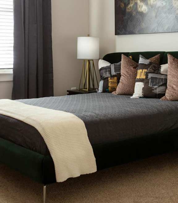 a bedroom with a bed and pillows at Esplanade District Apartments, Little Rock