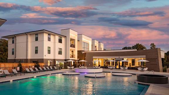 a large swimming pool in front of a hotel at Esplanade District Apartments, Little Rock, AR,72114