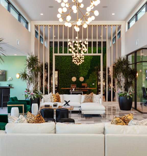 a living room filled with furniture and plants at Esplanade District Apartments, Little Rock