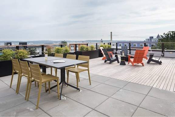 A table with chairs is set up on a patio.