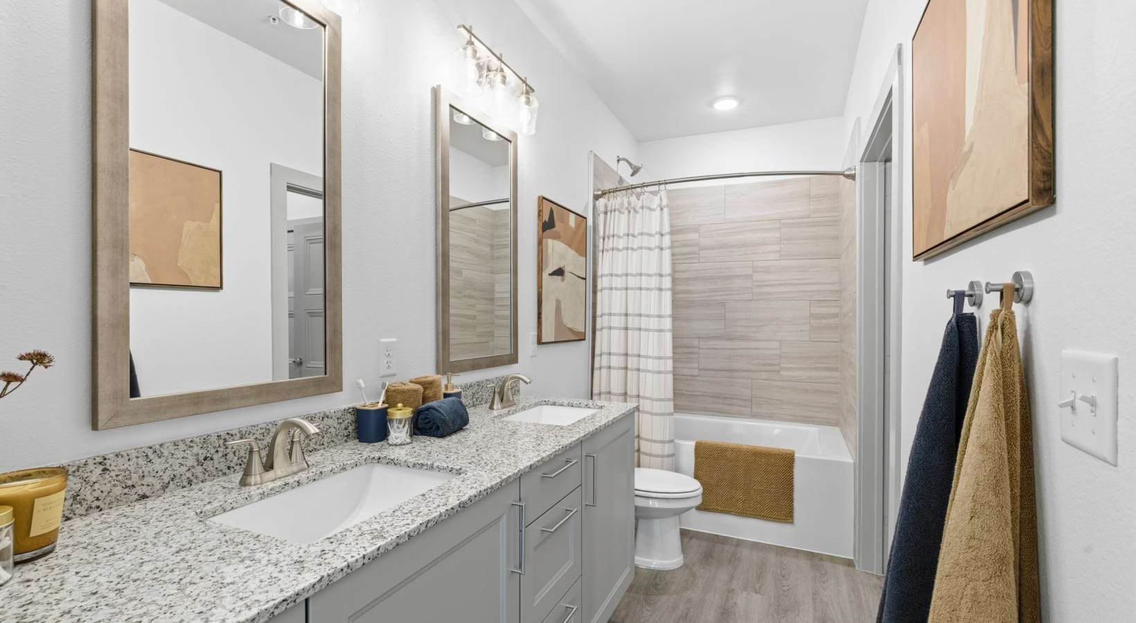 bathroom with tub and mirrors