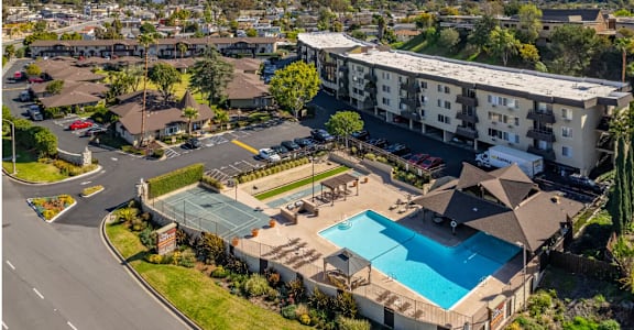 an aerial view of the resort style pool and tennis courts at the club at rolling hills in