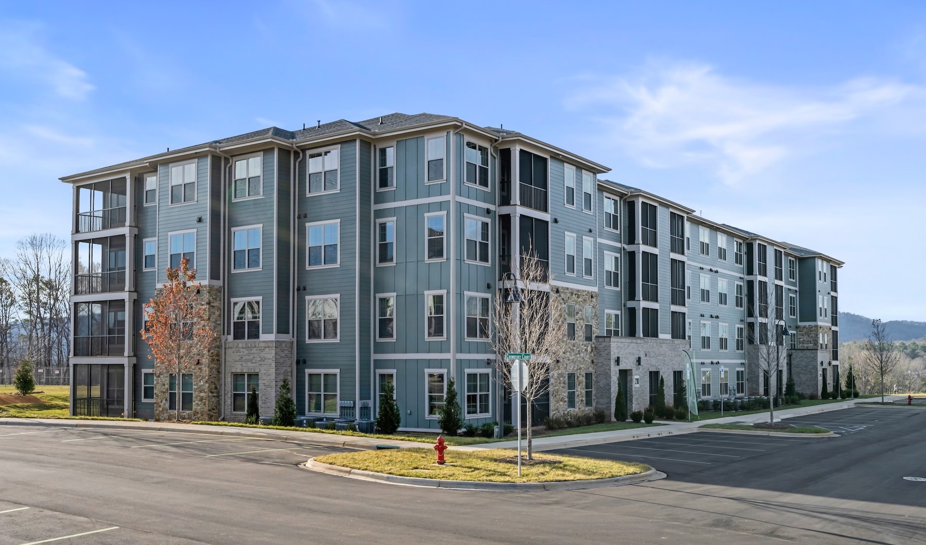 a multi-story building with a parking lot