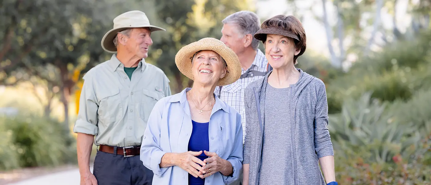 A group of residents take a walk on a nature path