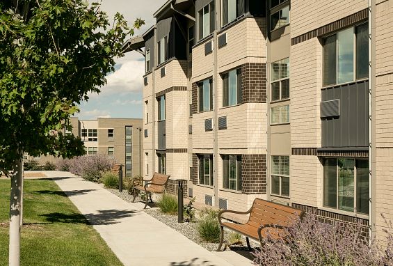 alt="Landscaped paths and outdoor seating"