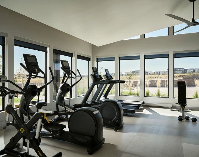alt="Fitness center with cardio machines and weights"