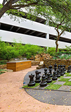 a large chess board in the courtyard of an apartment building