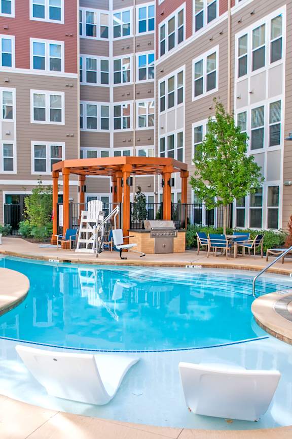 a swimming pool in the middle of two apartment buildings