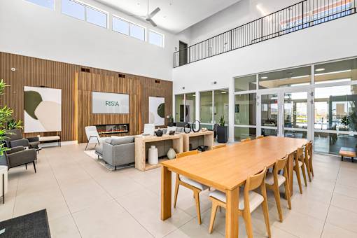 A conference room with a long table and chairs.