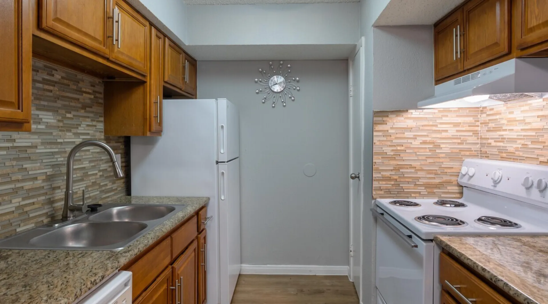 Charming kitchen with warm wood cabinets, sleek granite countertops, and stylish tiled backsplash layout.