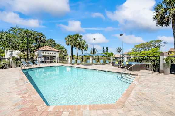 A swimming pool surrounded by a brick patio at Waterview at Coconut Creek, Coconut Creek