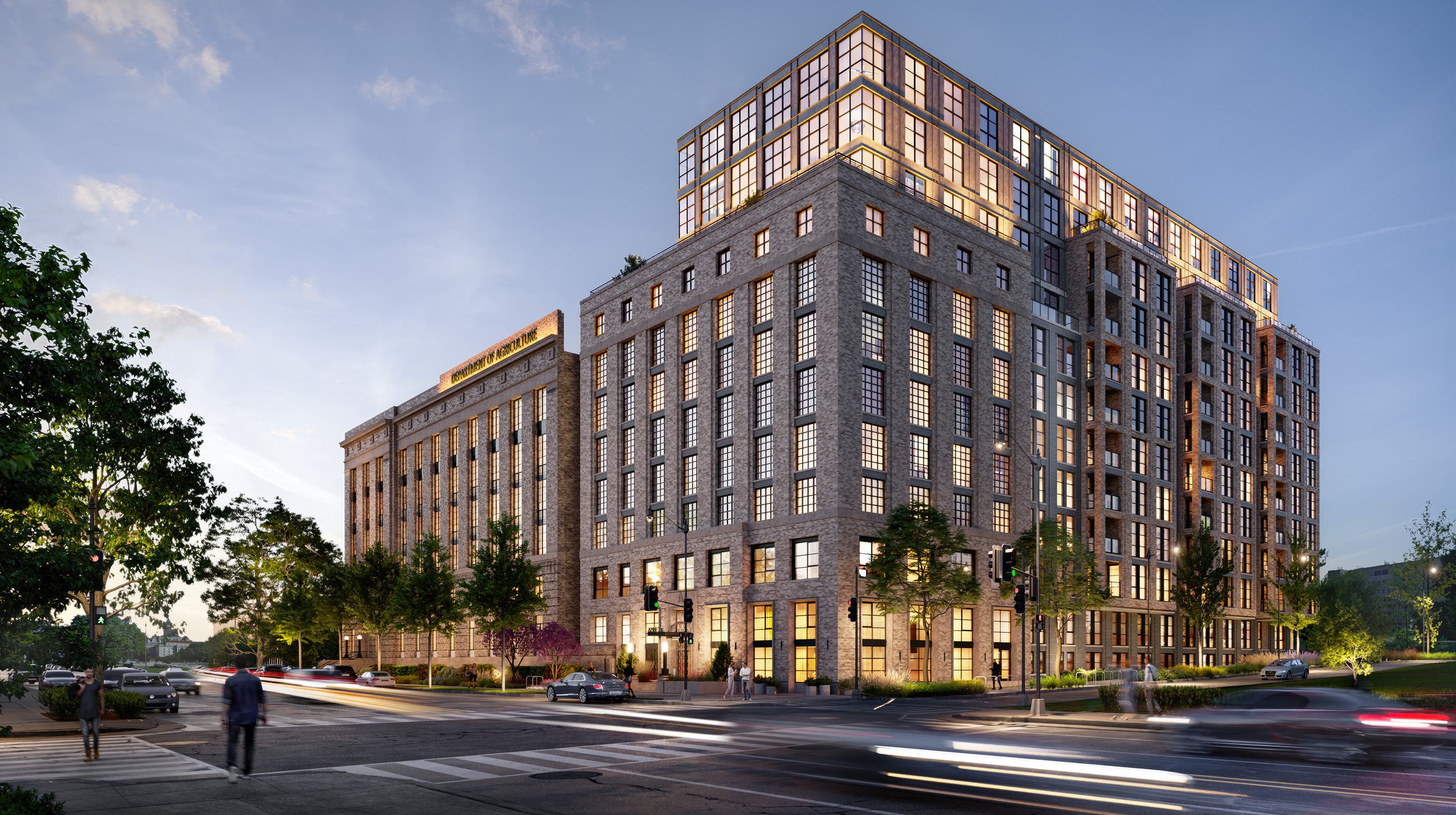 Street-level view of Annex on 12th in Southwest DC at sunset, showcasing its blend of restored historic brick architecture and modern residential addition with large grid windows and upper-level glass accents.
