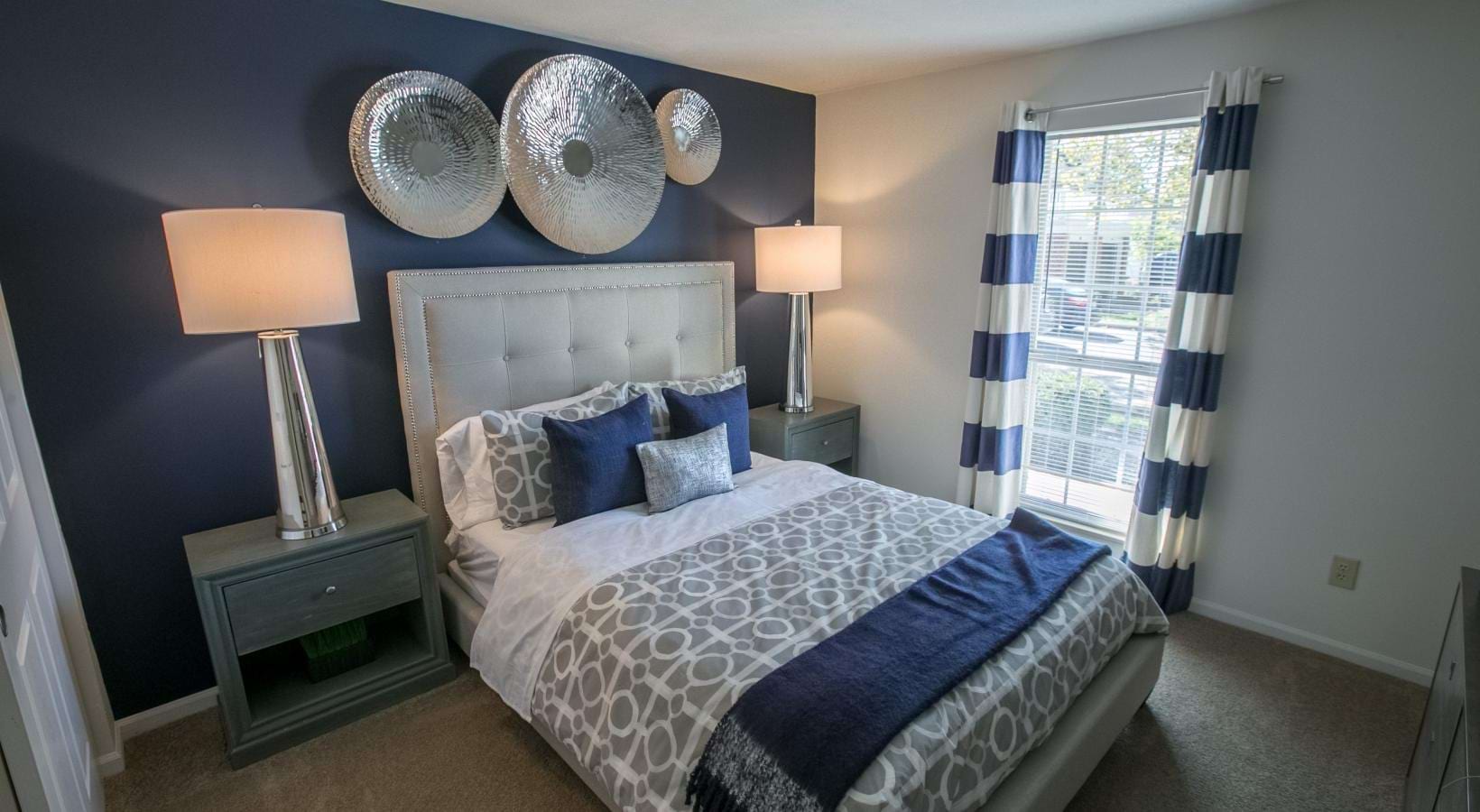 a bedroom with a bed and lamps