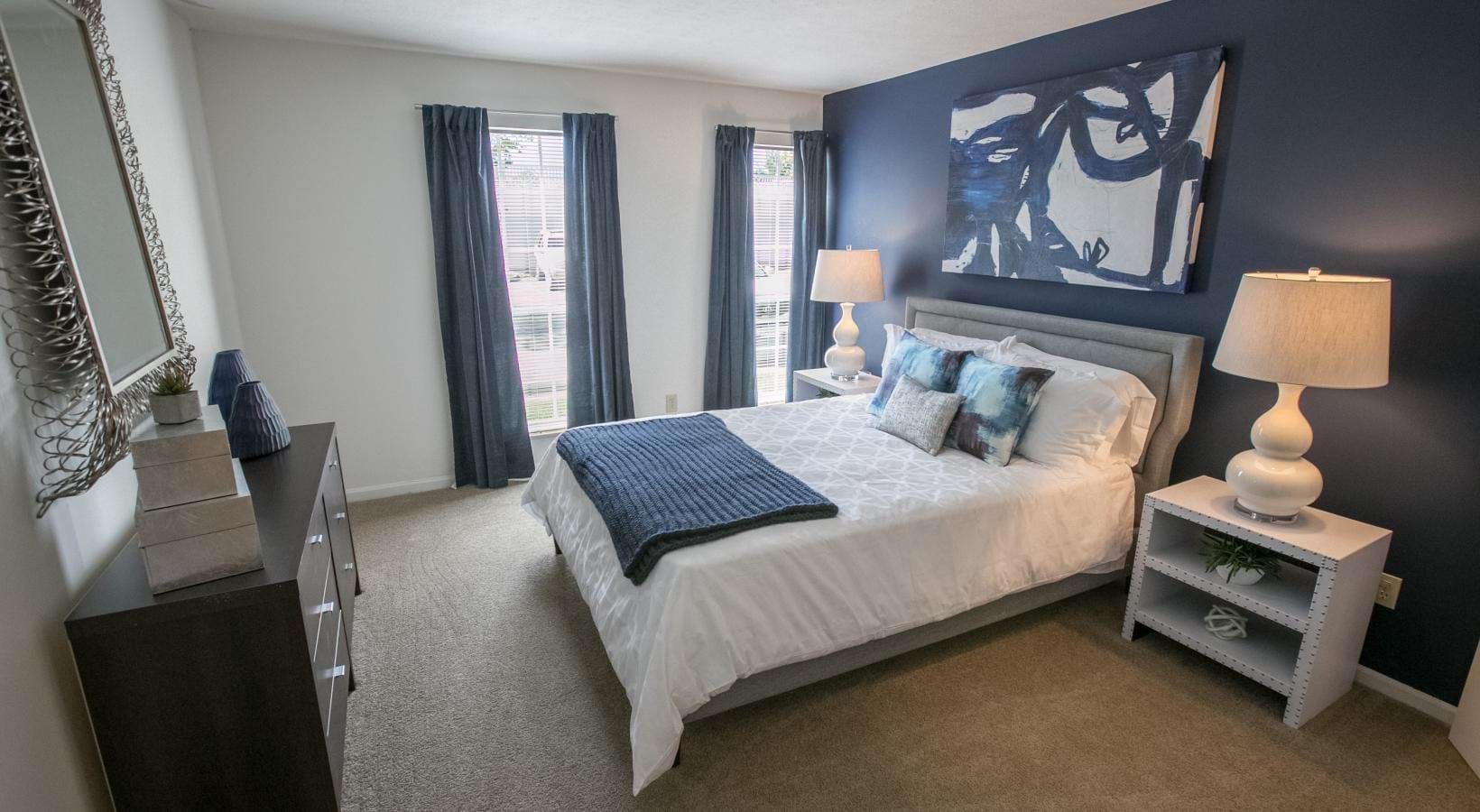 a bedroom with a bed and lamps