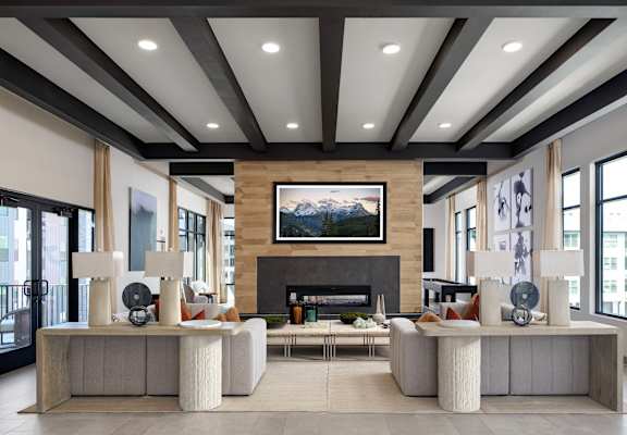A modern living room with a fireplace and a large painting above it.