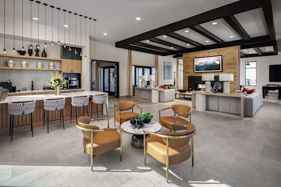 A modern kitchen with a dining table and chairs.
