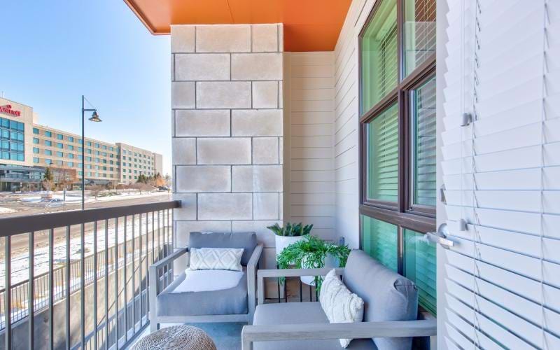 a deck with a chair and a table on it