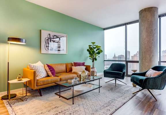 A living room with a green wall and a large window.
