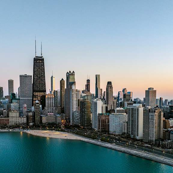 A city skyline with a large body of water in the foreground.