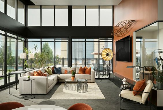 alt="Clubhouse lounge with TV viewing area"