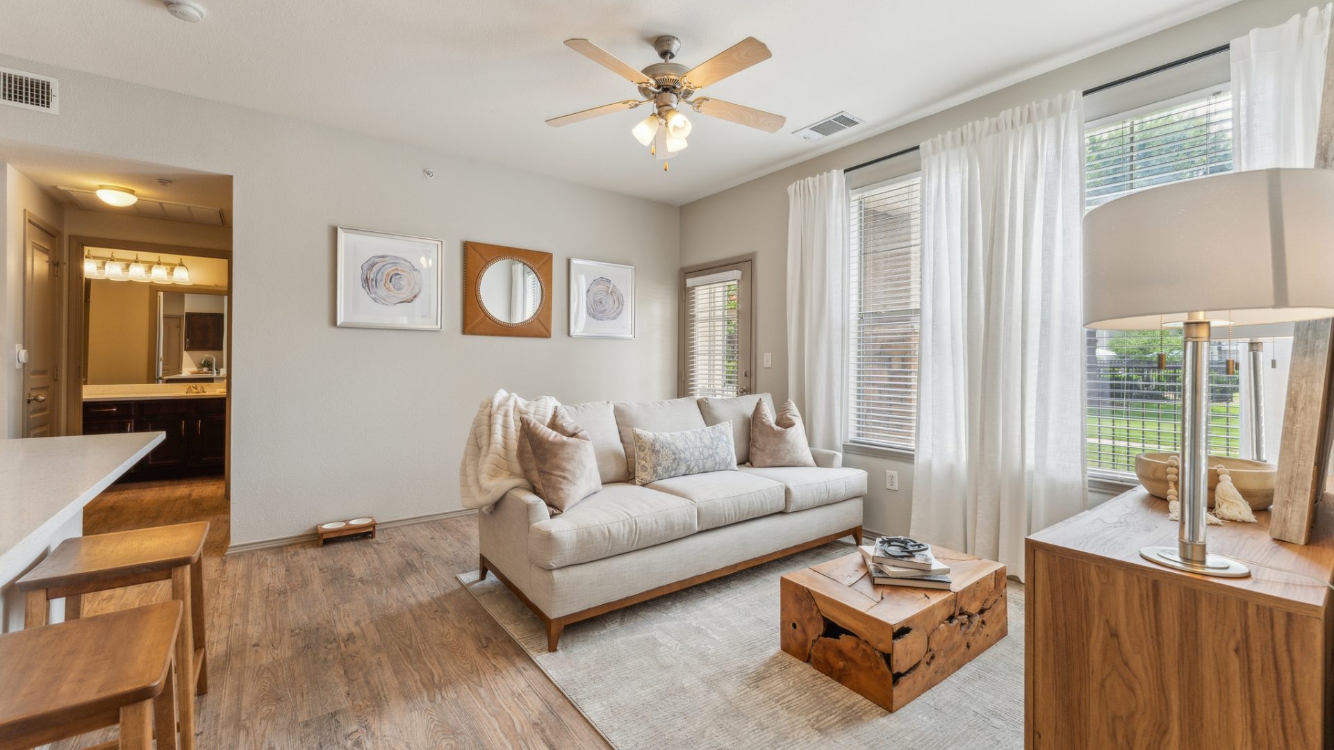 the living room has hardwood floors and a ceiling fan at The  Wyatt at Presidio Junction