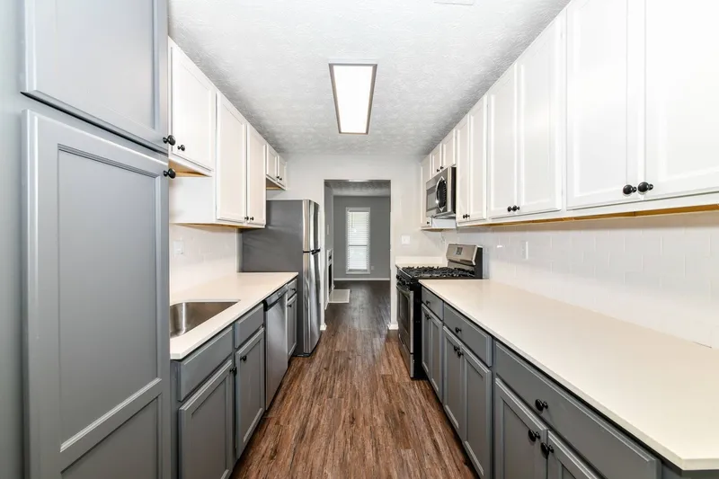 Galley kitchen with white and gray cabinets
