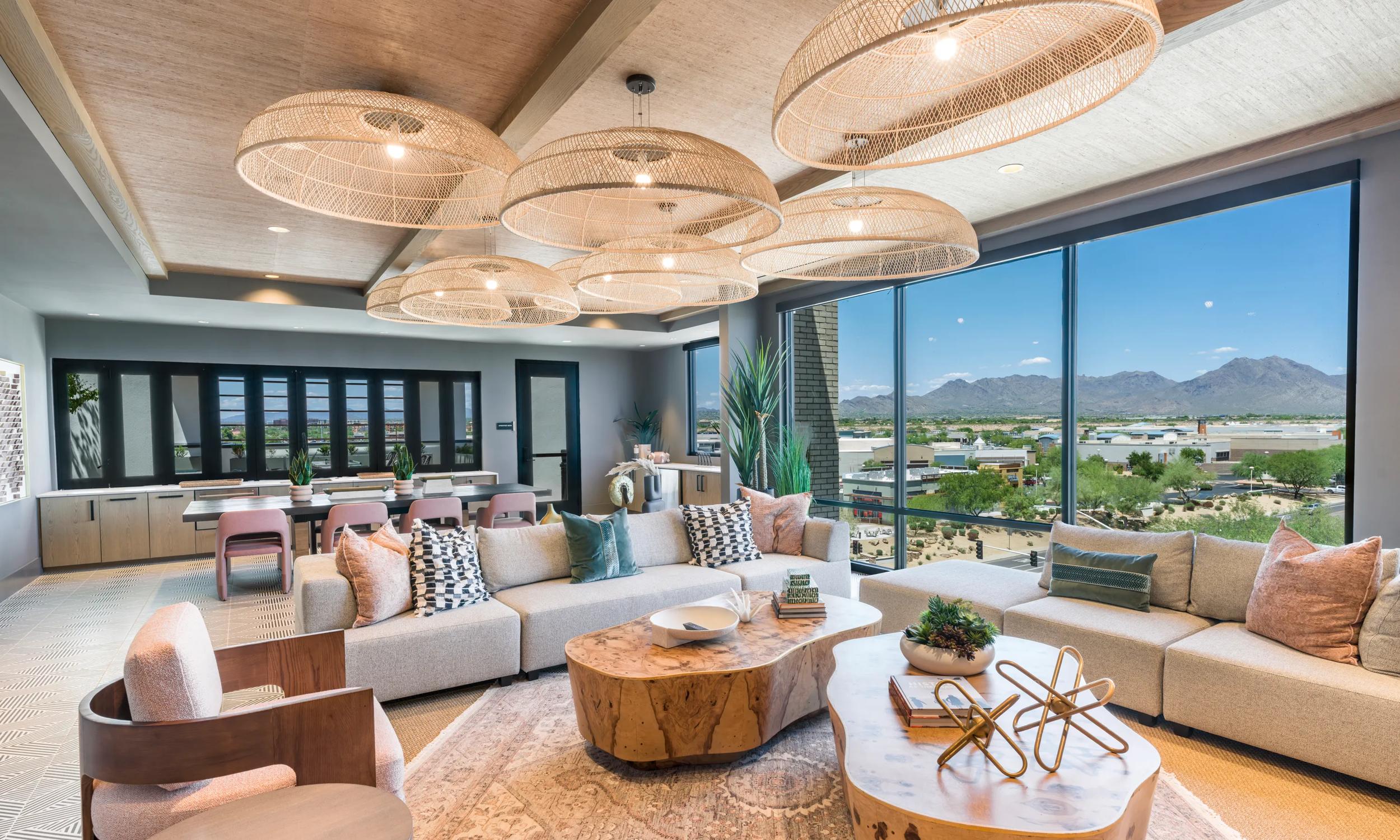 Luxurious living room with panoramic mountain views, featuring elegant wicker lighting, stylish furniture, and a cozy ambiance.