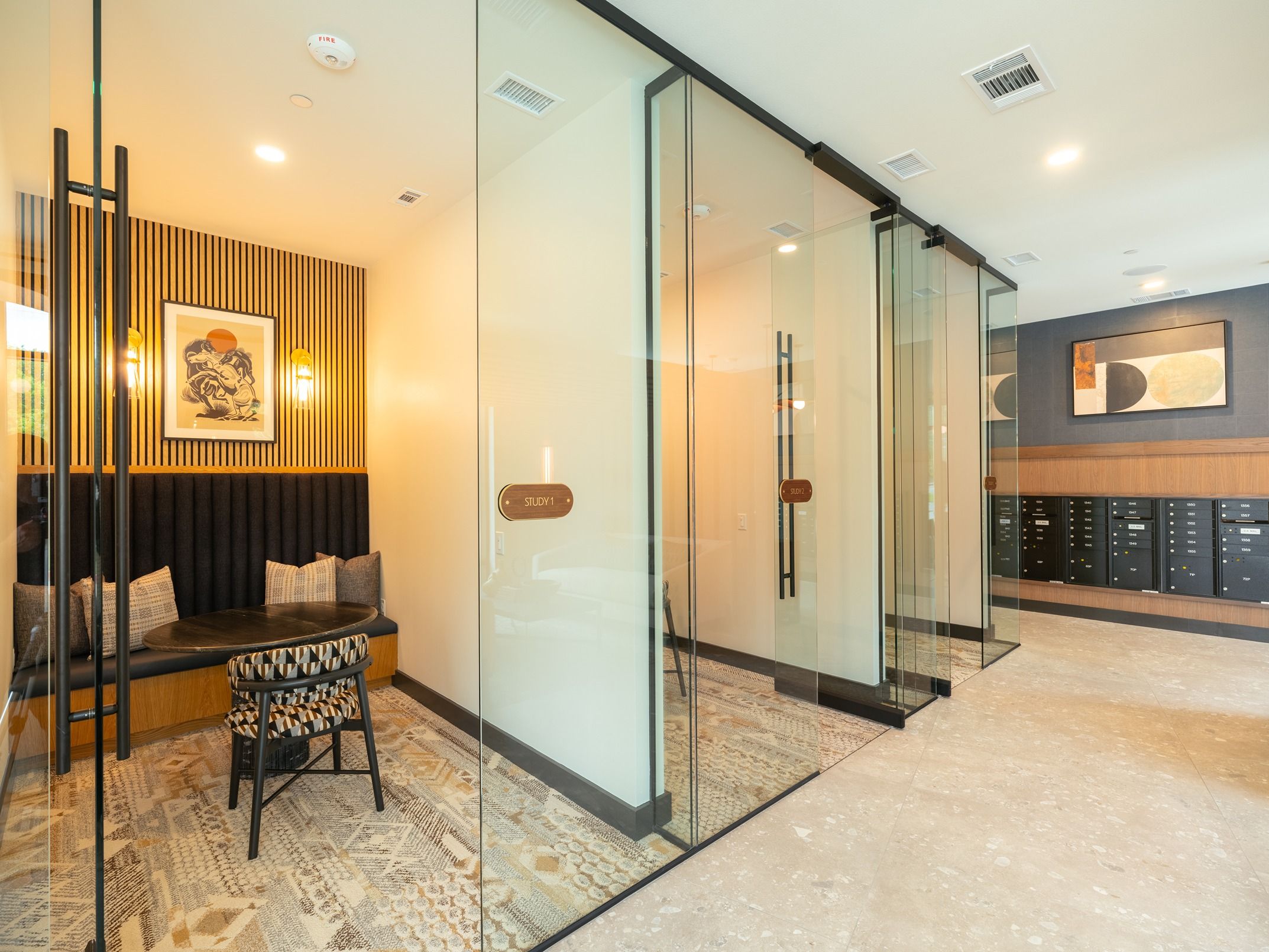 Modern office space with glass meeting rooms and cozy seating.